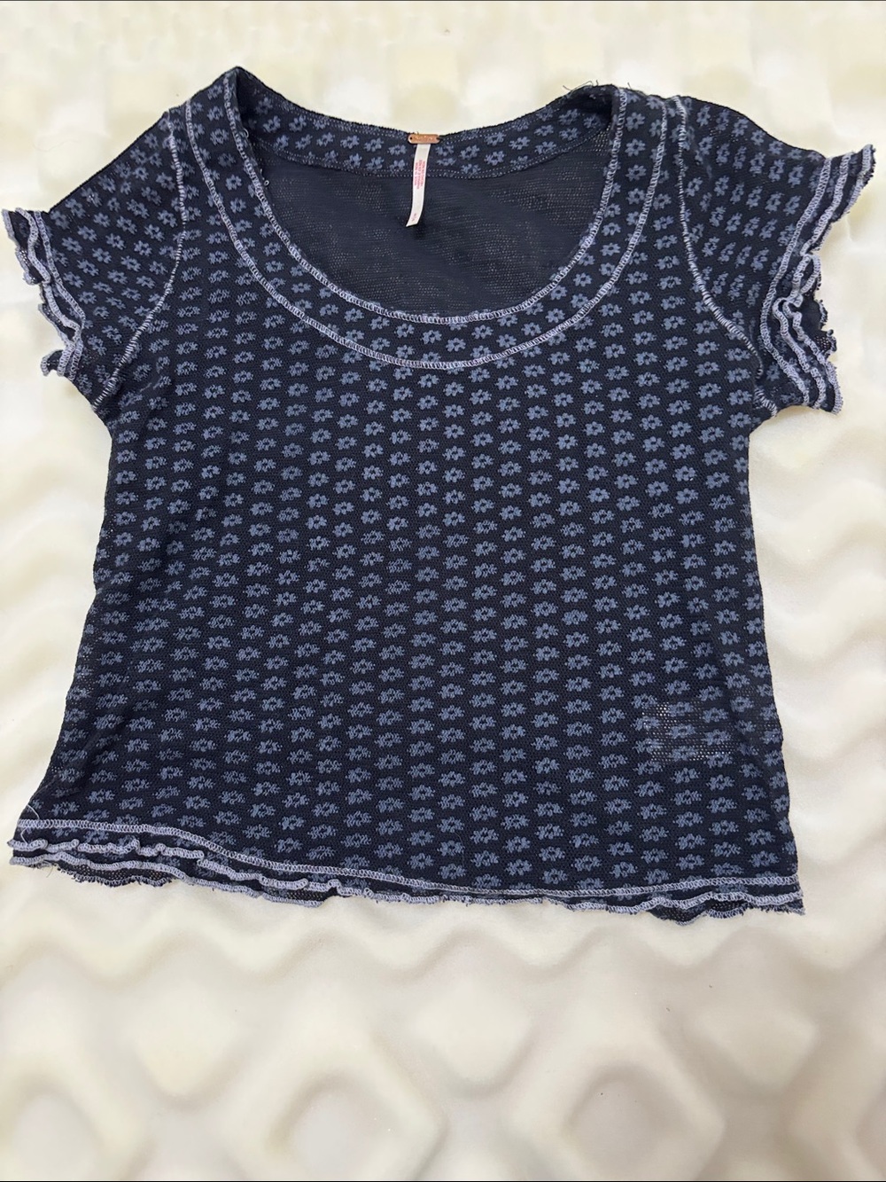 Free People black short ruffled sleeves with a grey floral print.